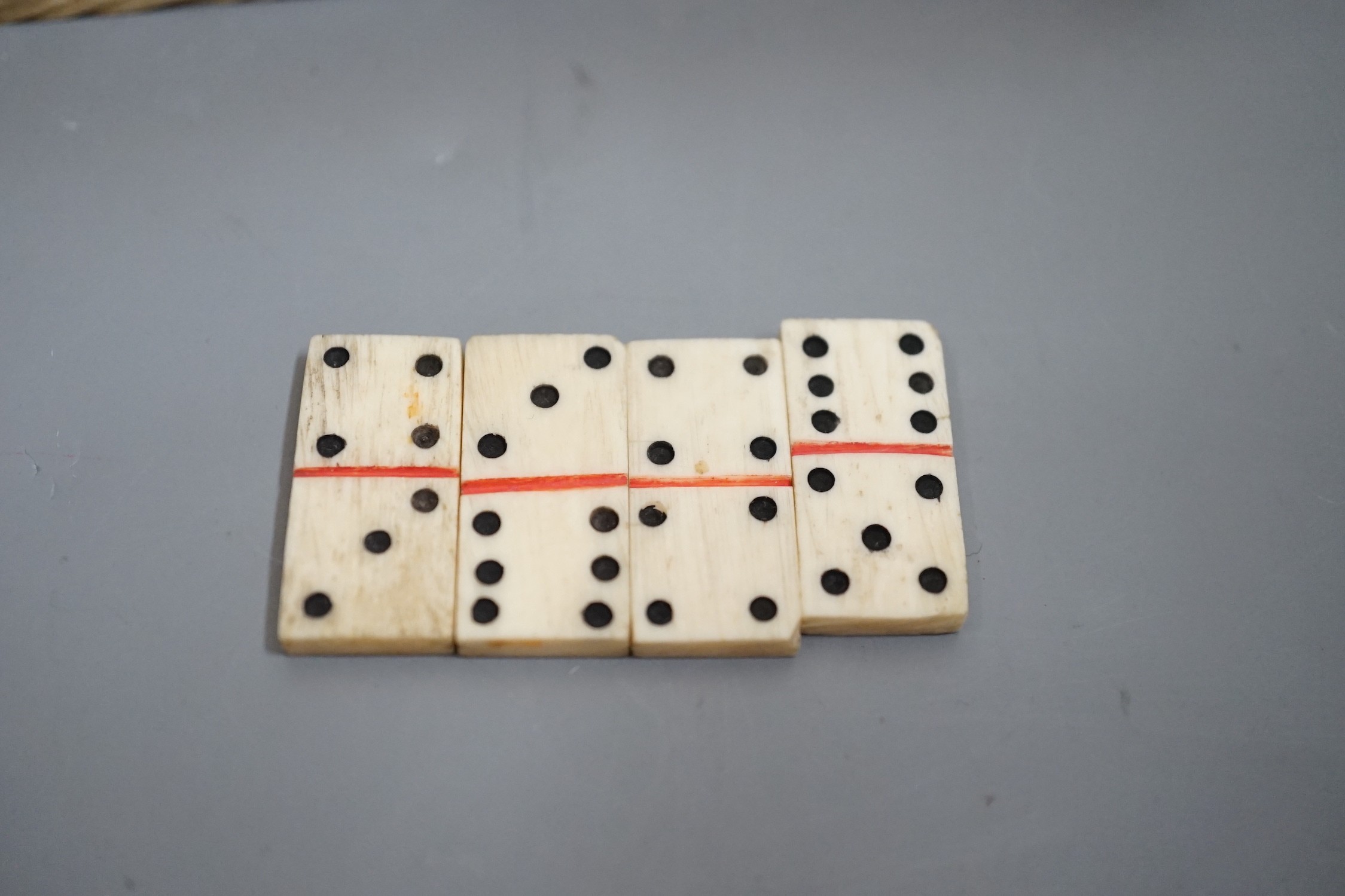 A Napoleonic Prisoner of War bone domino set, box 14cm wide